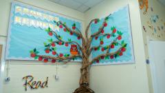 Colourful wall display featuring an apple tree