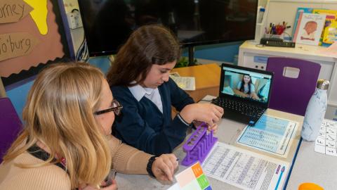 The ghost of his the contents of the Test Tube, whilst the girl working from home looks on via a computer screen