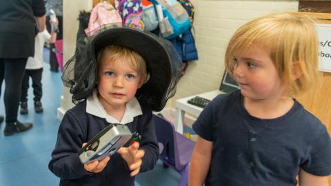 Early years pupils learning how to use a camera